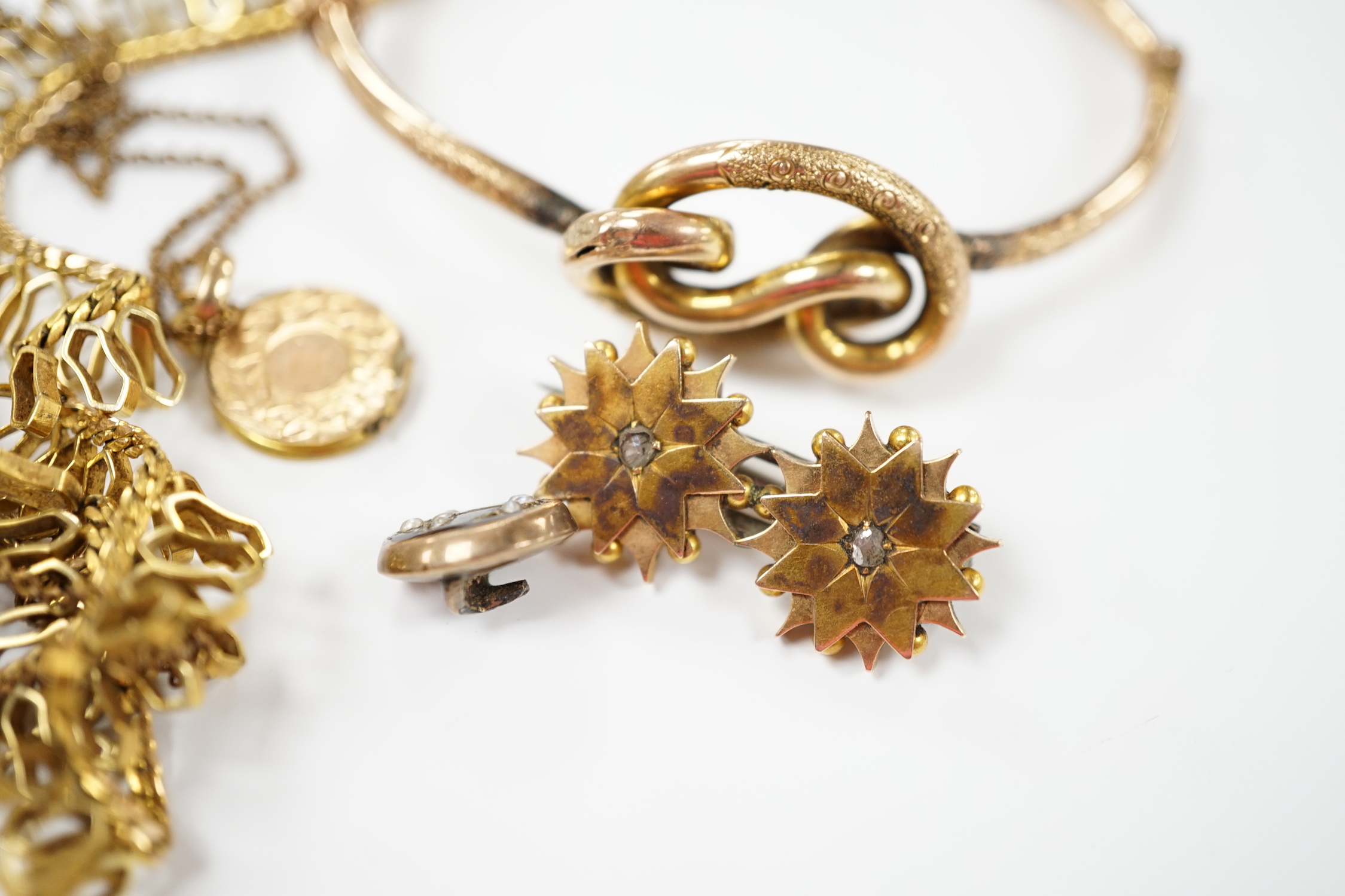 A 9ct. gold fringe necklace, 49cm(a.f.) a 9ct. gold bangle, 25.9 grams, a gold plated locket on a gold plated fine chain, a Victorian yellow metal and two stone diamond set brooch and a stick pin head.